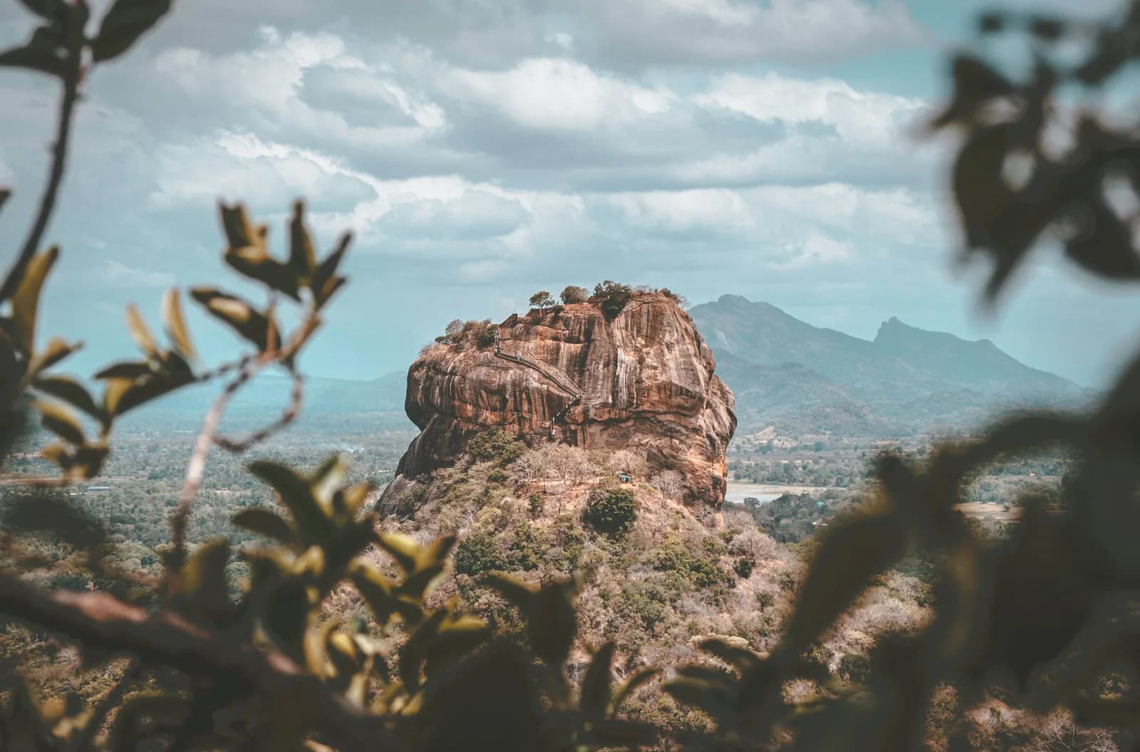 Iconic UNESCO World Heritage Sigiriya Lion Rock citadel rising above tropical jungle.